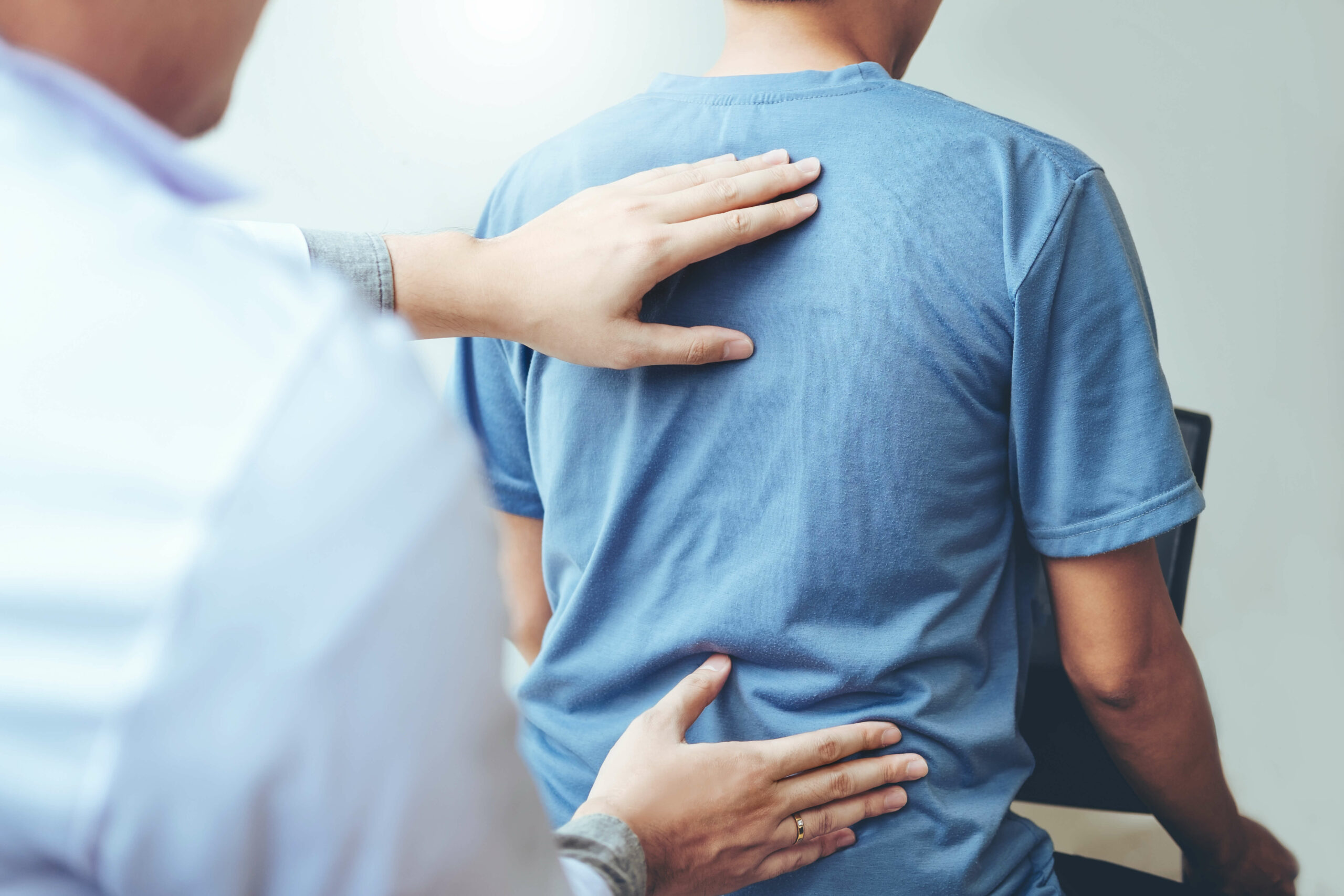 Physician working on patients back